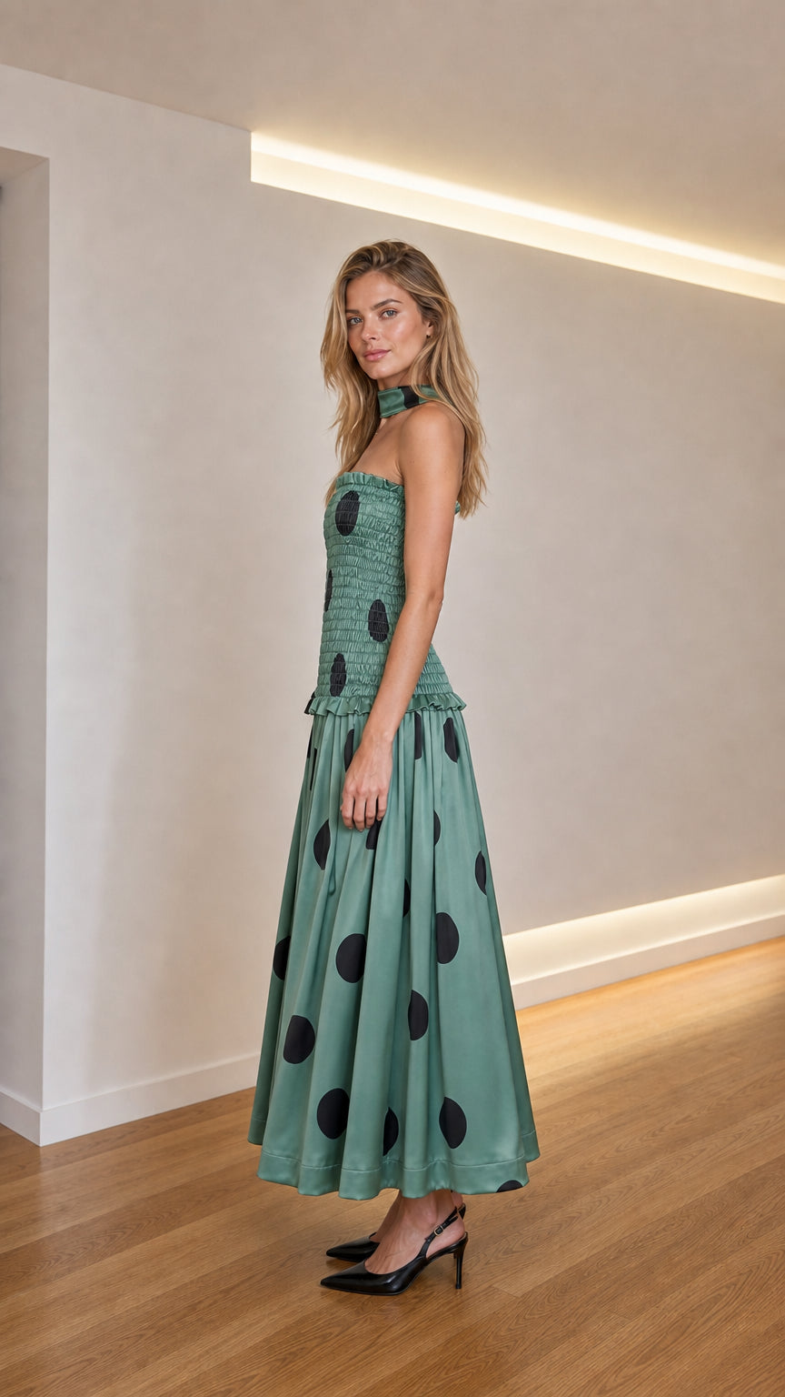 Side profile view of sage green polka dot midi dress