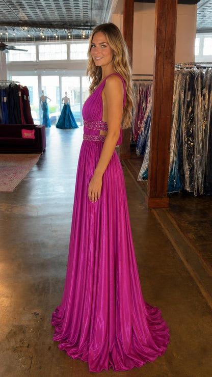 Side profile view of magenta evening gown in boutique