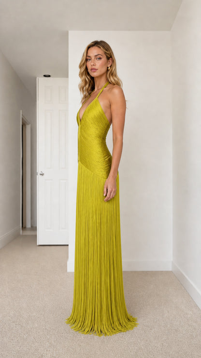 Side profile of model in chartreuse halter fringe evening gown