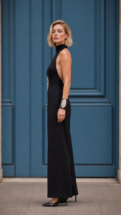 Side profile view of black wide-leg jumpsuit showing open back design