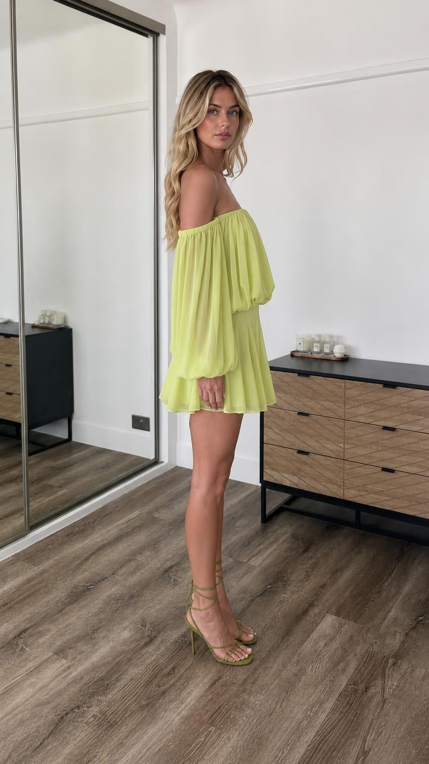 Side profile view of lime off-the-shoulder mini dress