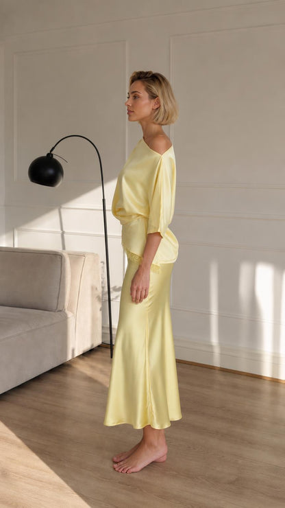 Woman wearing yellow satin set side view