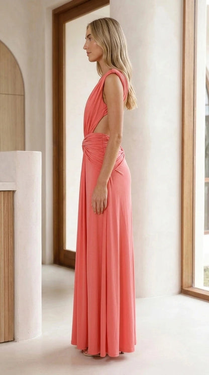 Side view of model showing cutout and drape of coral maxi gown
