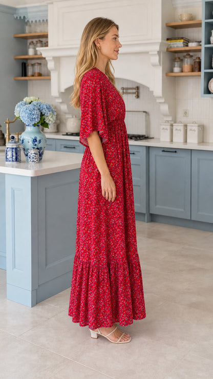 Side profile view of model wearing flowy red floral maxi dress