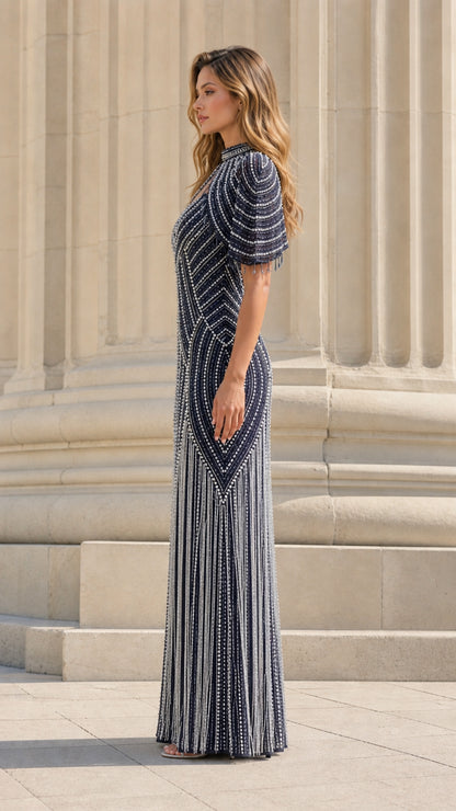 Model wearing navy beaded formal gown side profile