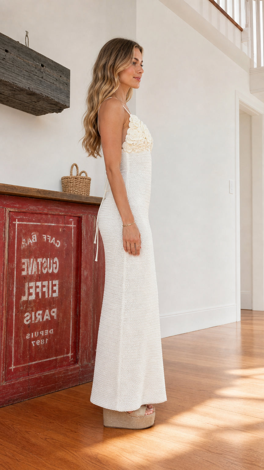 Side view of woman wearing white crochet maxi dress with heels