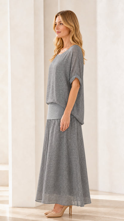 Side profile of model in grey shimmer maxi skirt set