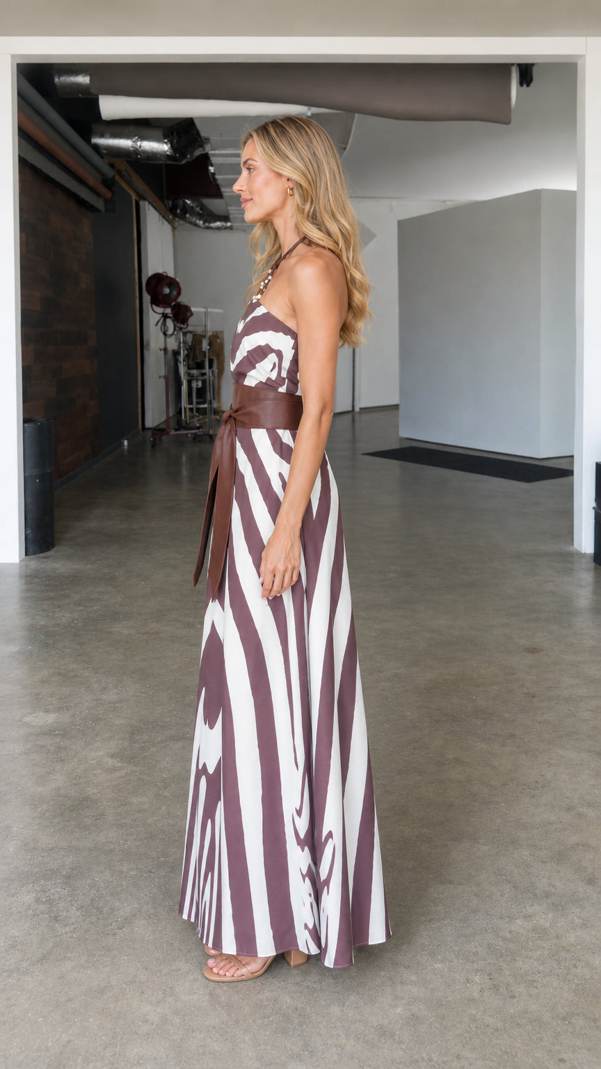 Side profile view of burgundy zebra maxi dress