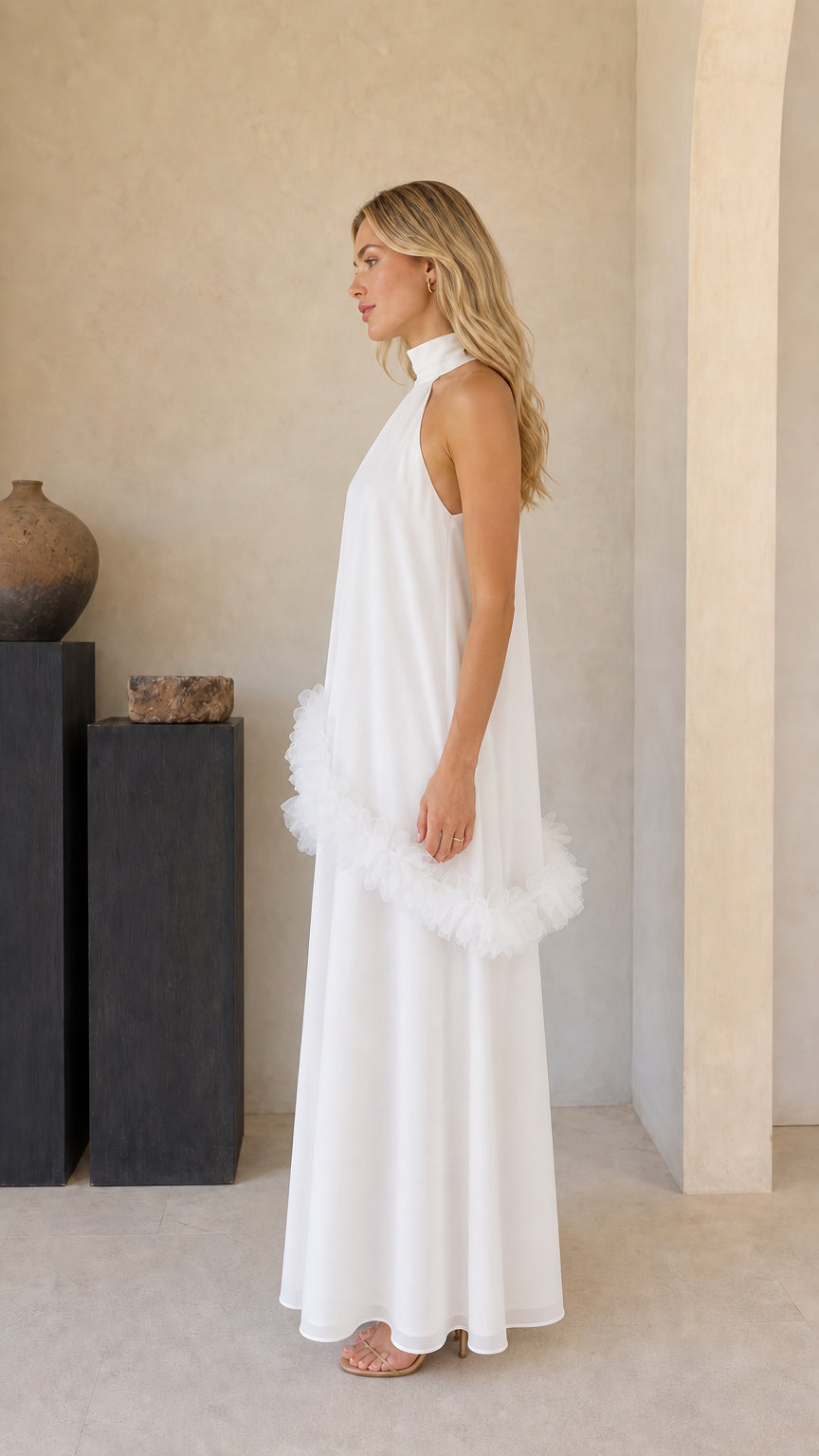 Side profile of model in white sleeveless tiered ruffle maxi gown