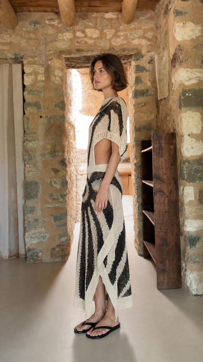 Side profile view of model in ivory knit maxi set