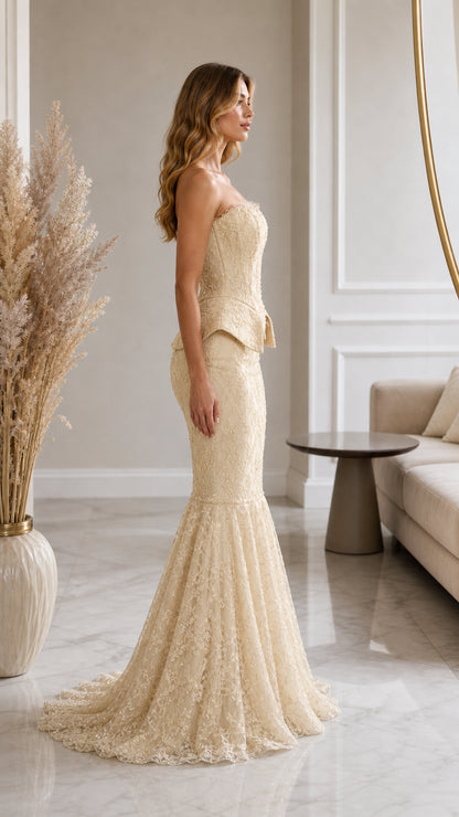 Side profile of champagne lace strapless evening gown with flared mermaid train