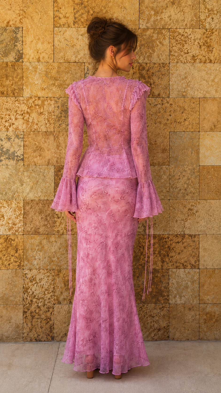Back view of model in light pink lace set with flared sleeves