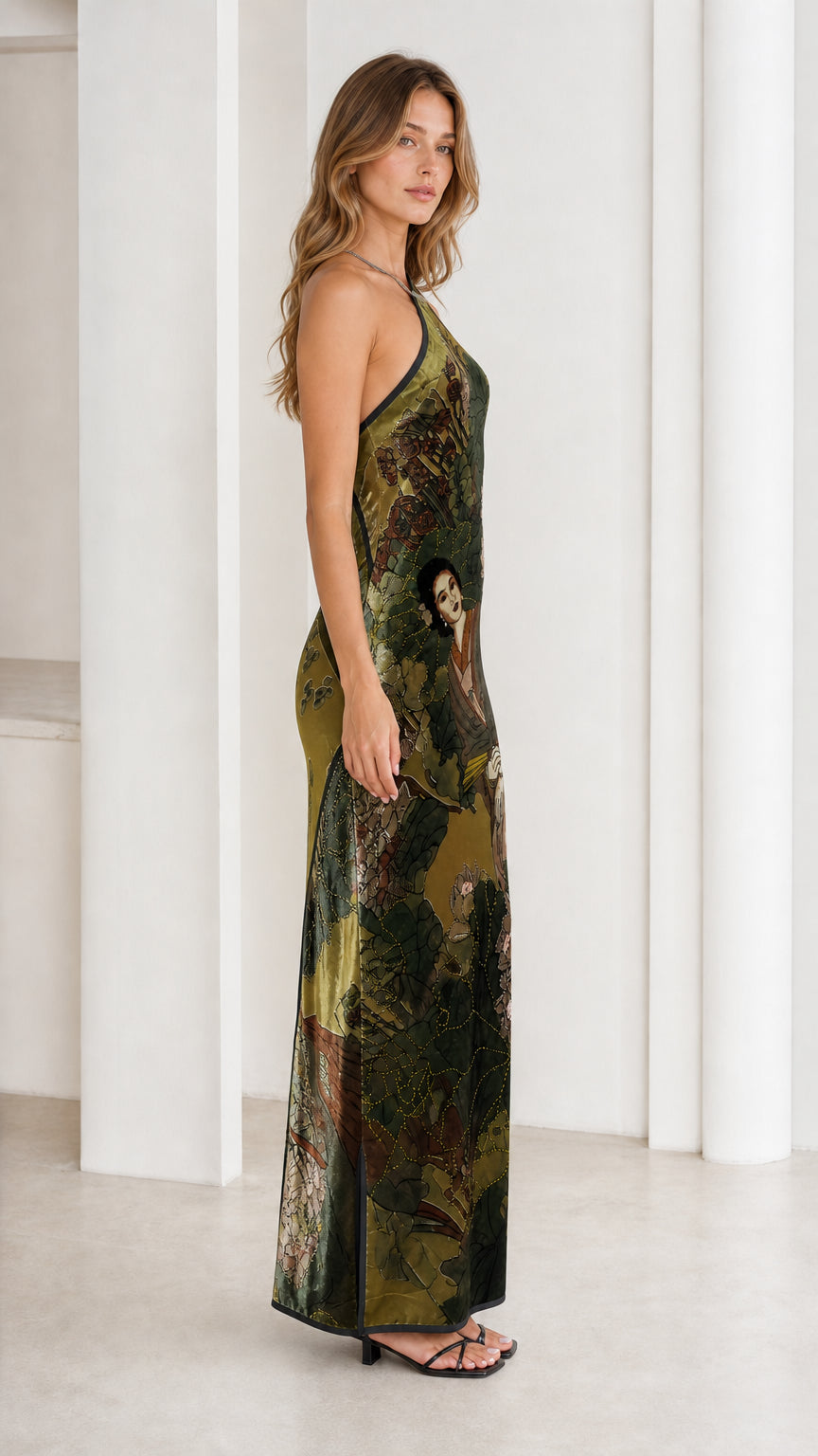 Model wearing olive green velvet halter maxi dress, side view