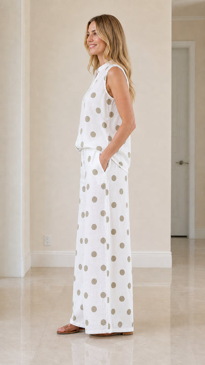 Woman wearing white polka dot two-piece set, side view