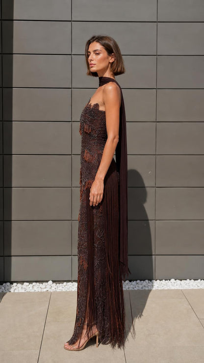 Side profile of model in brown beaded evening gown