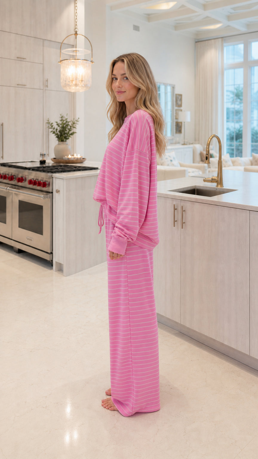 Side profile view of model wearing pink striped two-piece loungewear set