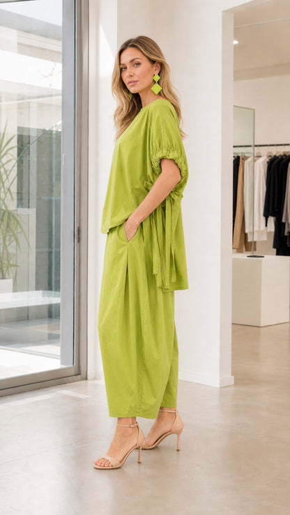Model wearing lime green two-piece set, side profile