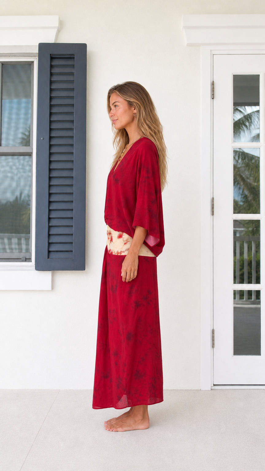 Side profile view of model in Wine Red v-neck draped maxi dress
