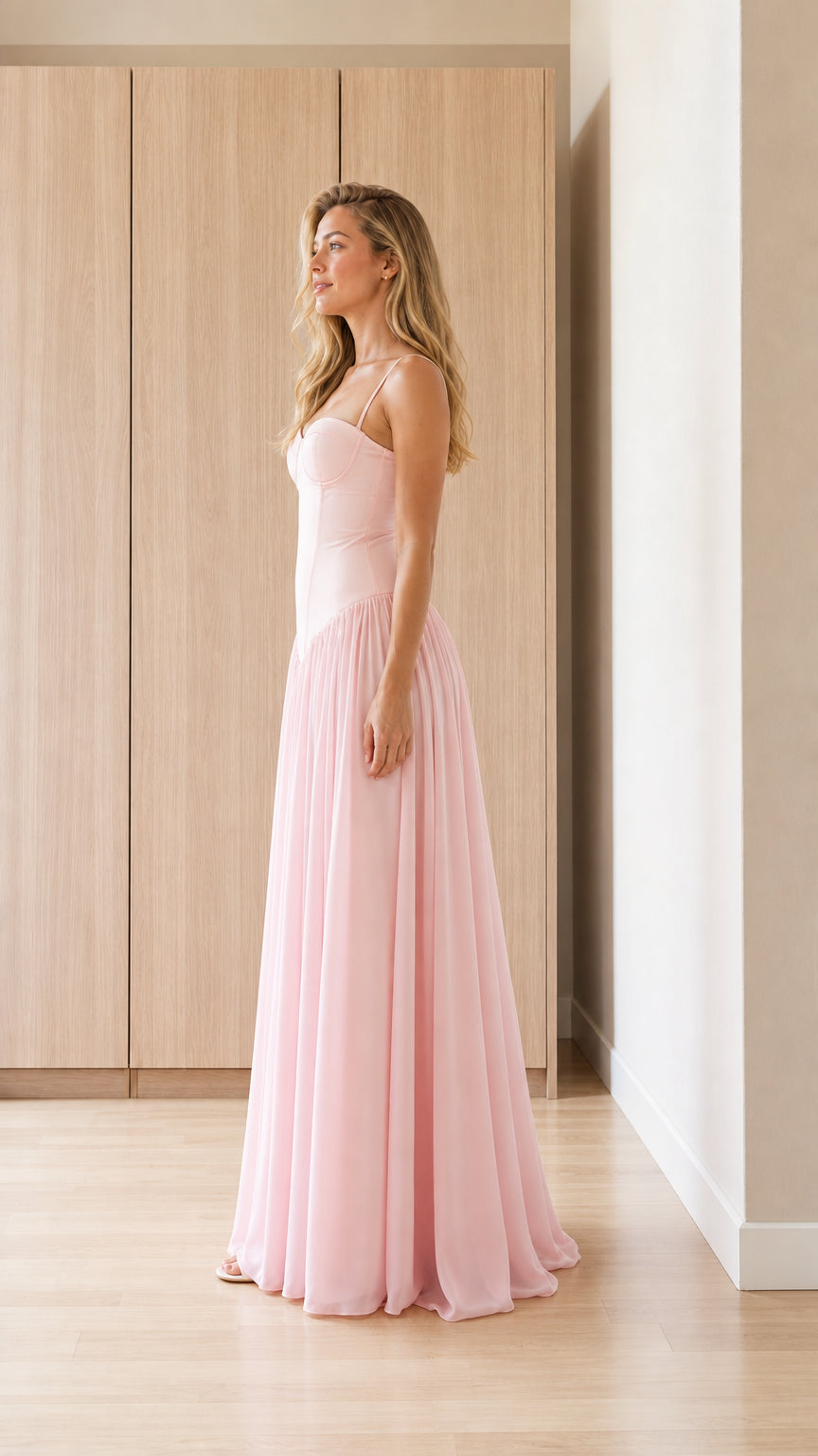 Side profile view of pink bustier maxi dress