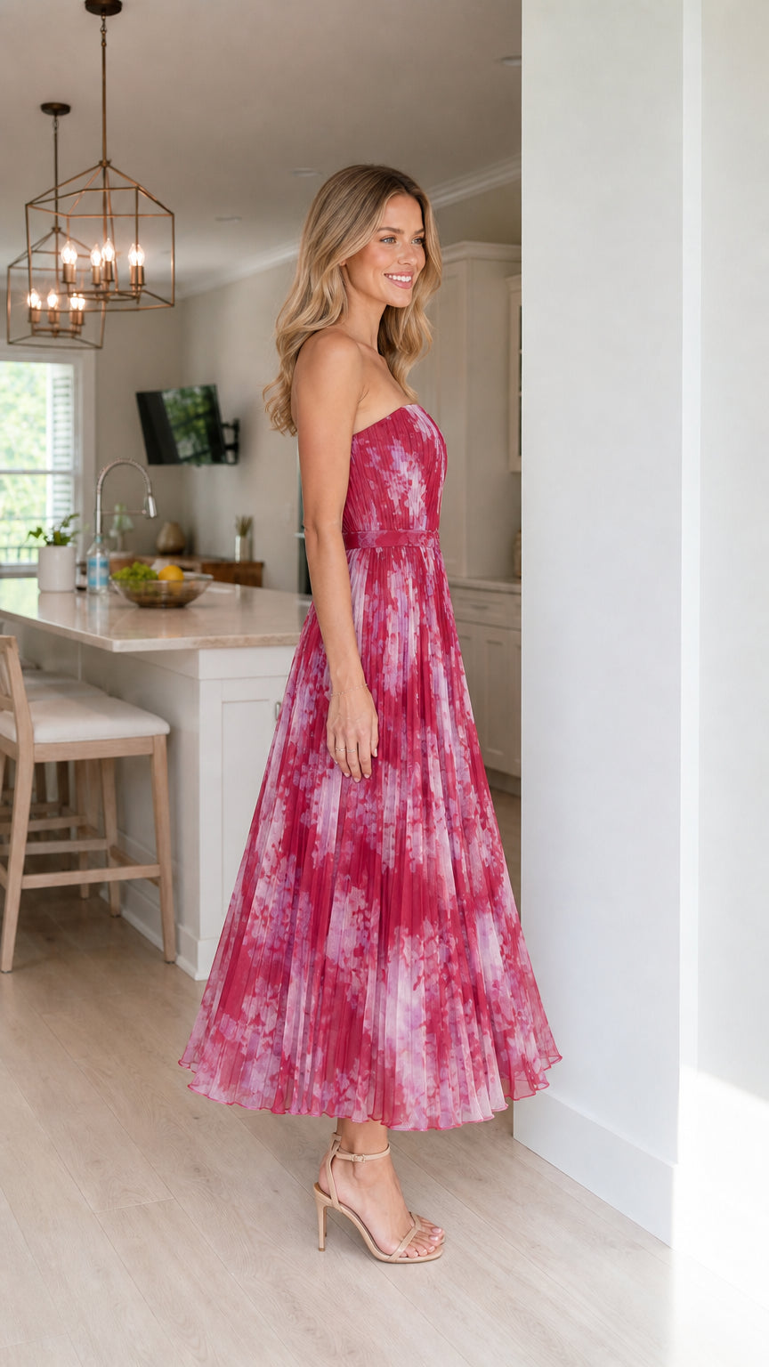 Side profile of woman in fuchsia floral midi dress