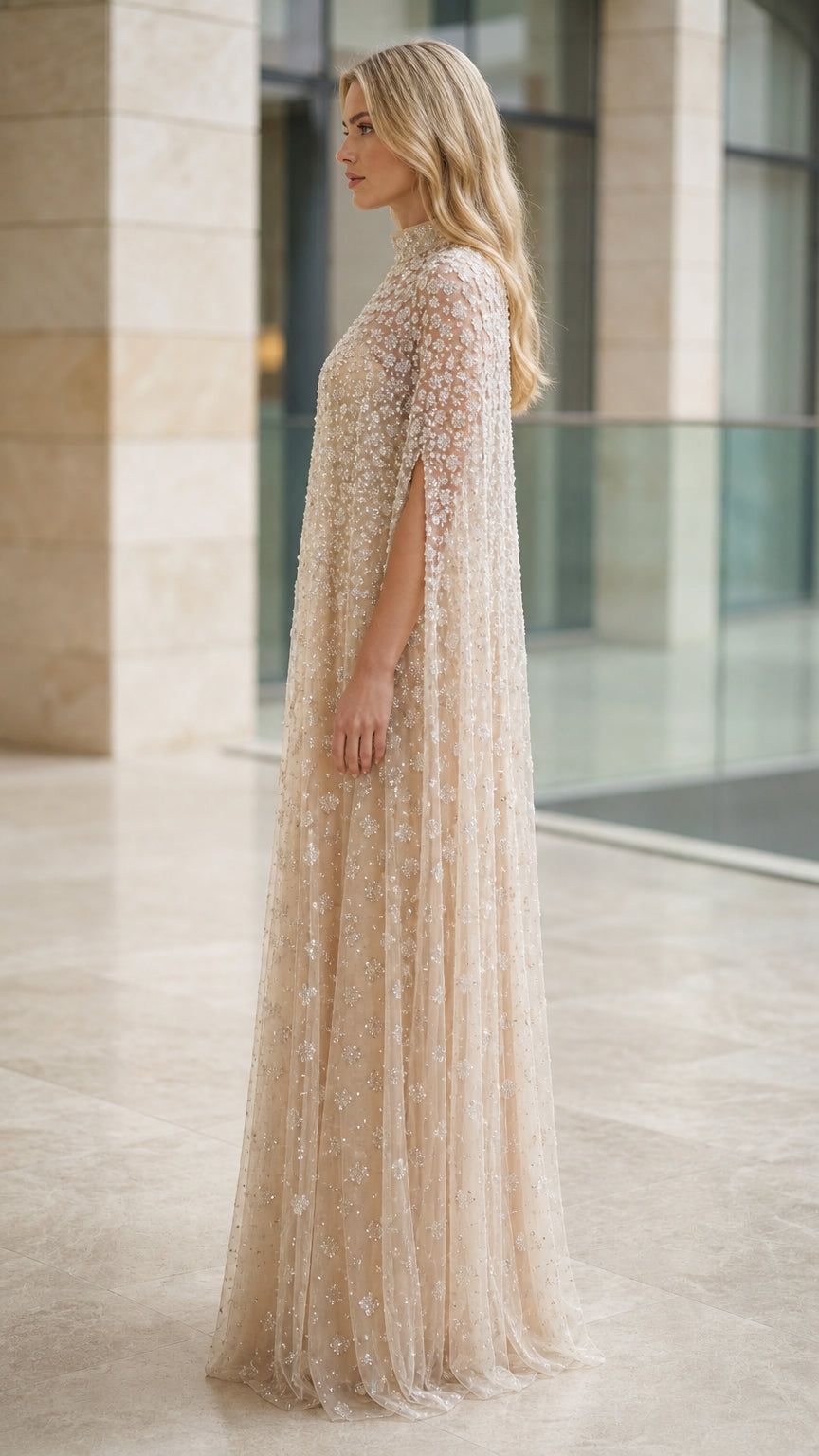 Side profile of champagne beaded cape formal maxi dress