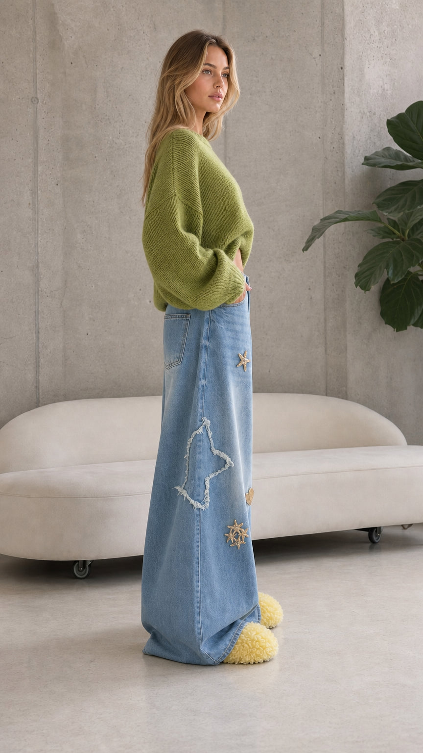 Side view of woman posing in light blue celestial star wide leg baggy denim trousers