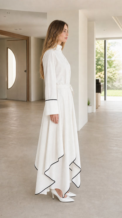 Side profile of woman in white maxi dress showing sleek silhouette and heels