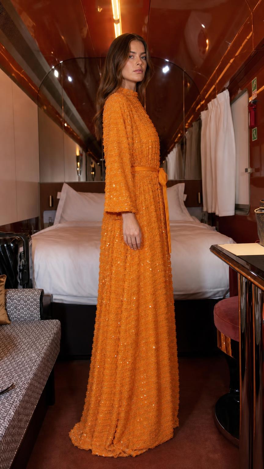 Side profile of orange textured sequin maxi dress