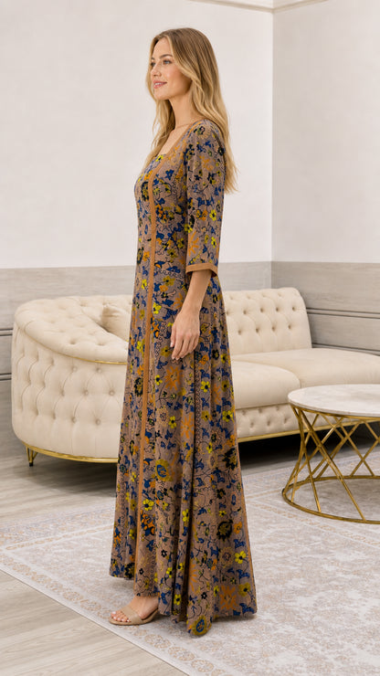 Side angle view of model wearing taupe floral long dress with 3/4 sleeves