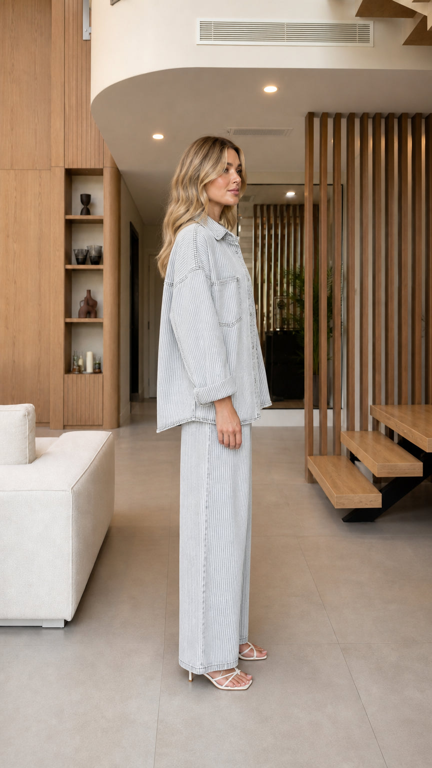 Side profile view of model wearing Light Blue striped two-piece denim set