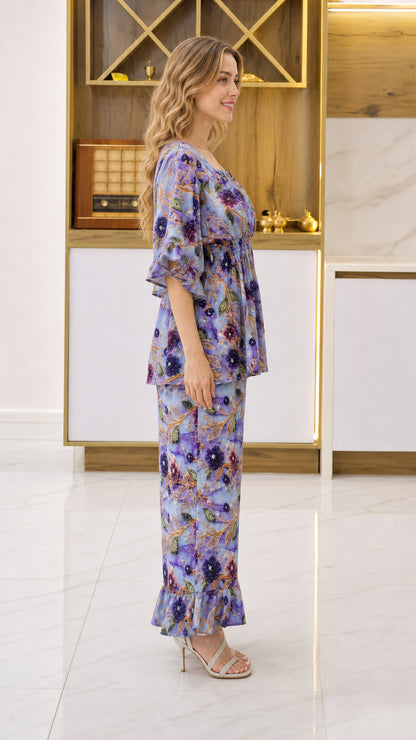 Side profile view of woman wearing Periwinkle Blue floral matching top and pant set