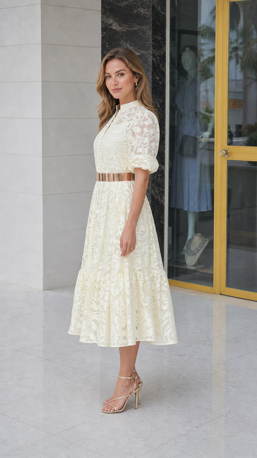 Side profile of model in off-white lace midi dress