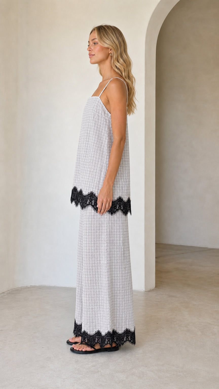 Model wearing white plaid two-piece set, side view