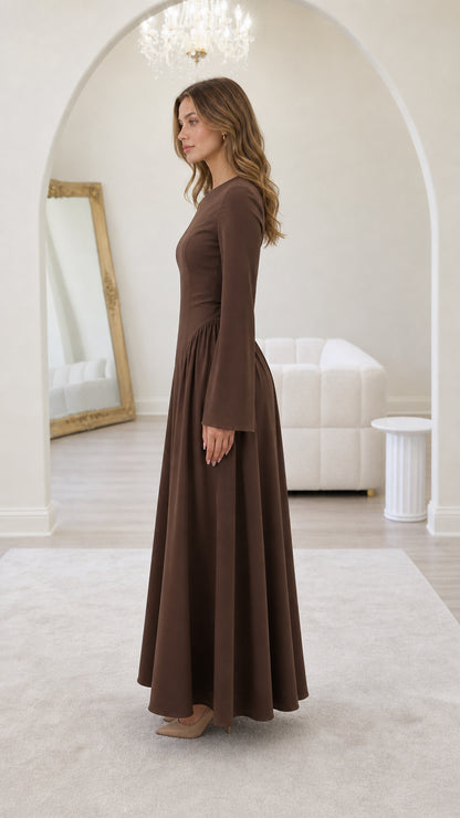 Side profile of model in brown maxi dress