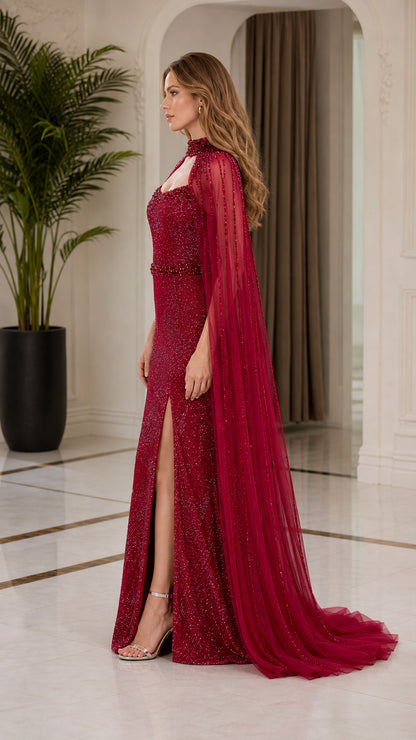 Side angle view of burgundy cape evening dress showing front slit and sweep train