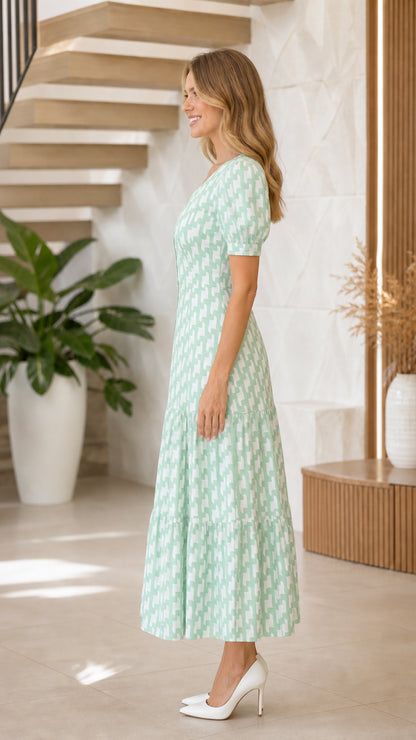 Side profile of model in mint green maxi dress