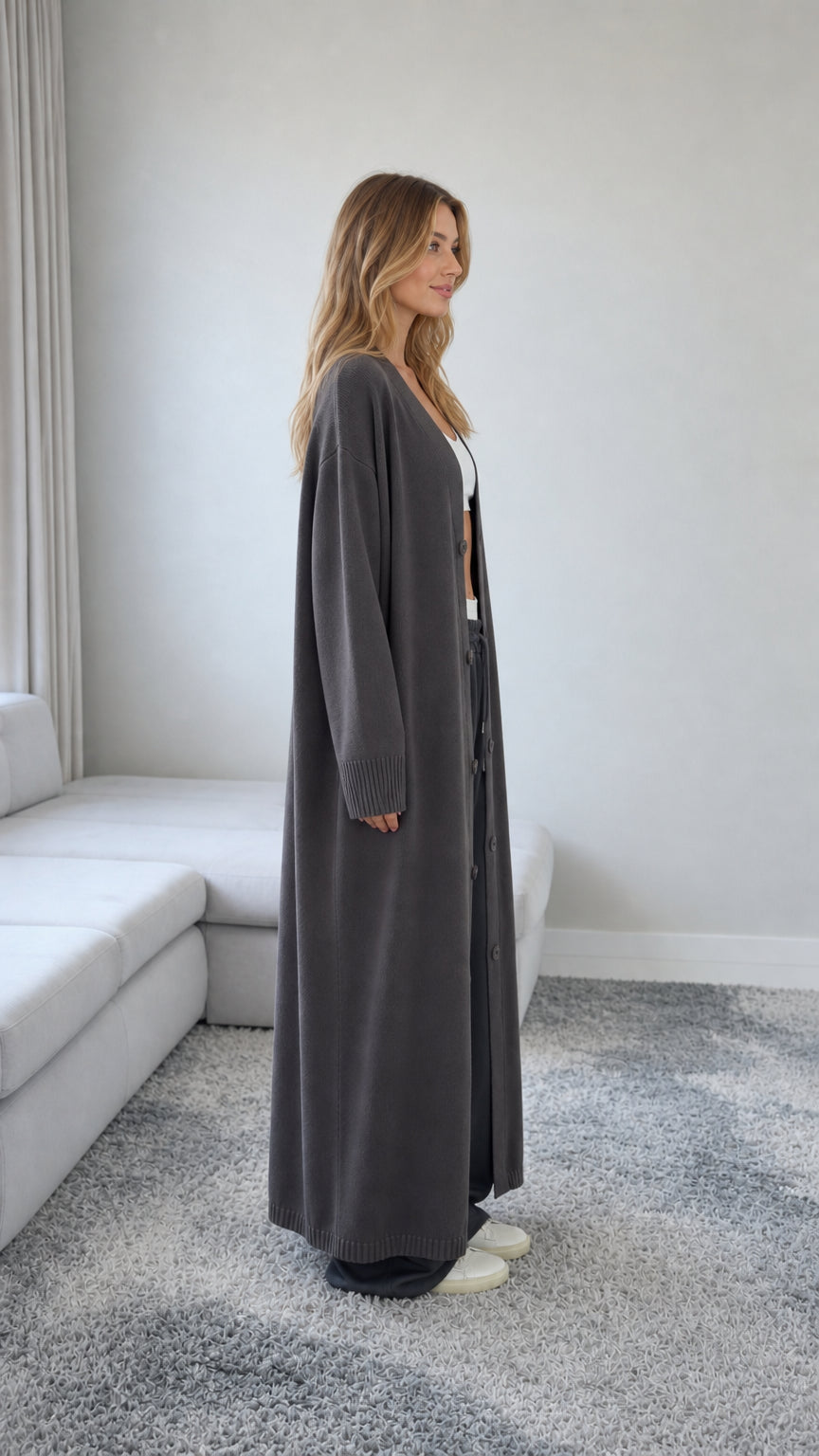 Side profile view of model wearing a Charcoal Grey longline knit cardigan