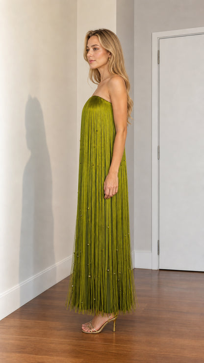 Side profile of woman wearing olive green fringe maxi dress with heels