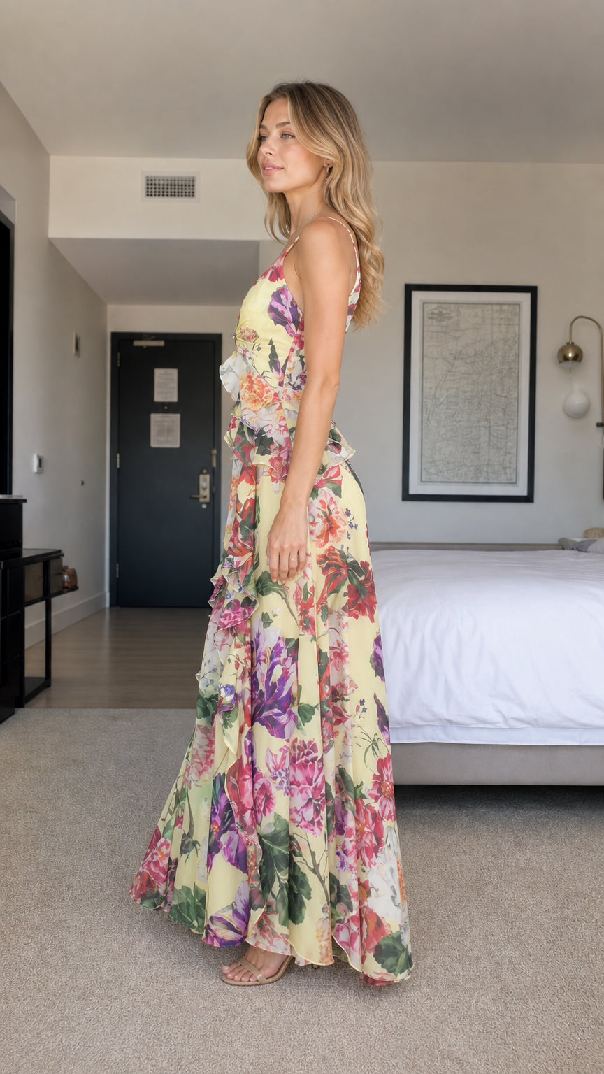 Side profile of model in yellow floral chiffon maxi dress
