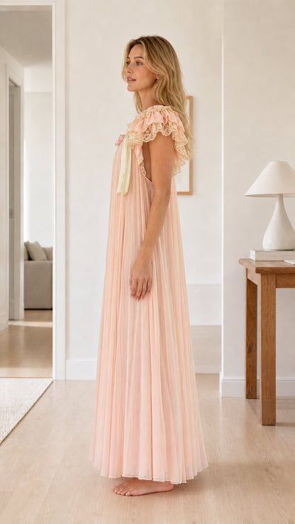 Side profile view of blush pink vintage-style pleated maxi nightgown dress