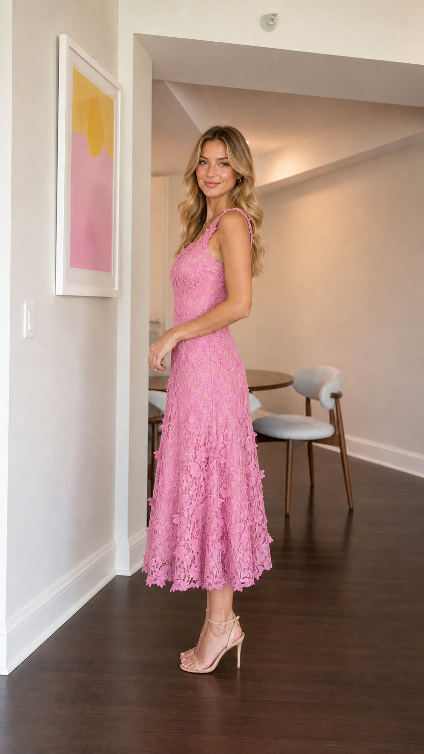 Model wearing pink floral lace midi dress from the side