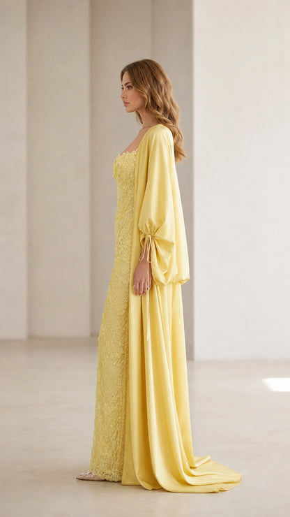 Side profile view of yellow evening gown and draped cape