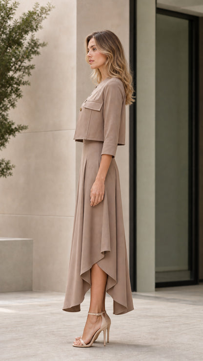 Side view of model wearing taupe two-piece cropped jacket and draped skirt set