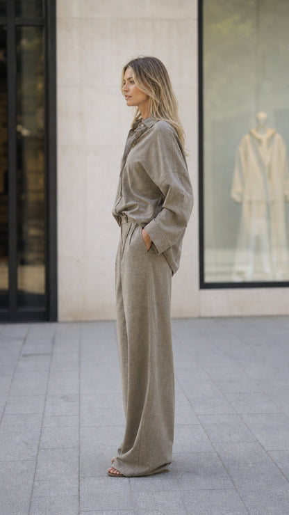 Side profile view of woman wearing taupe two-piece set