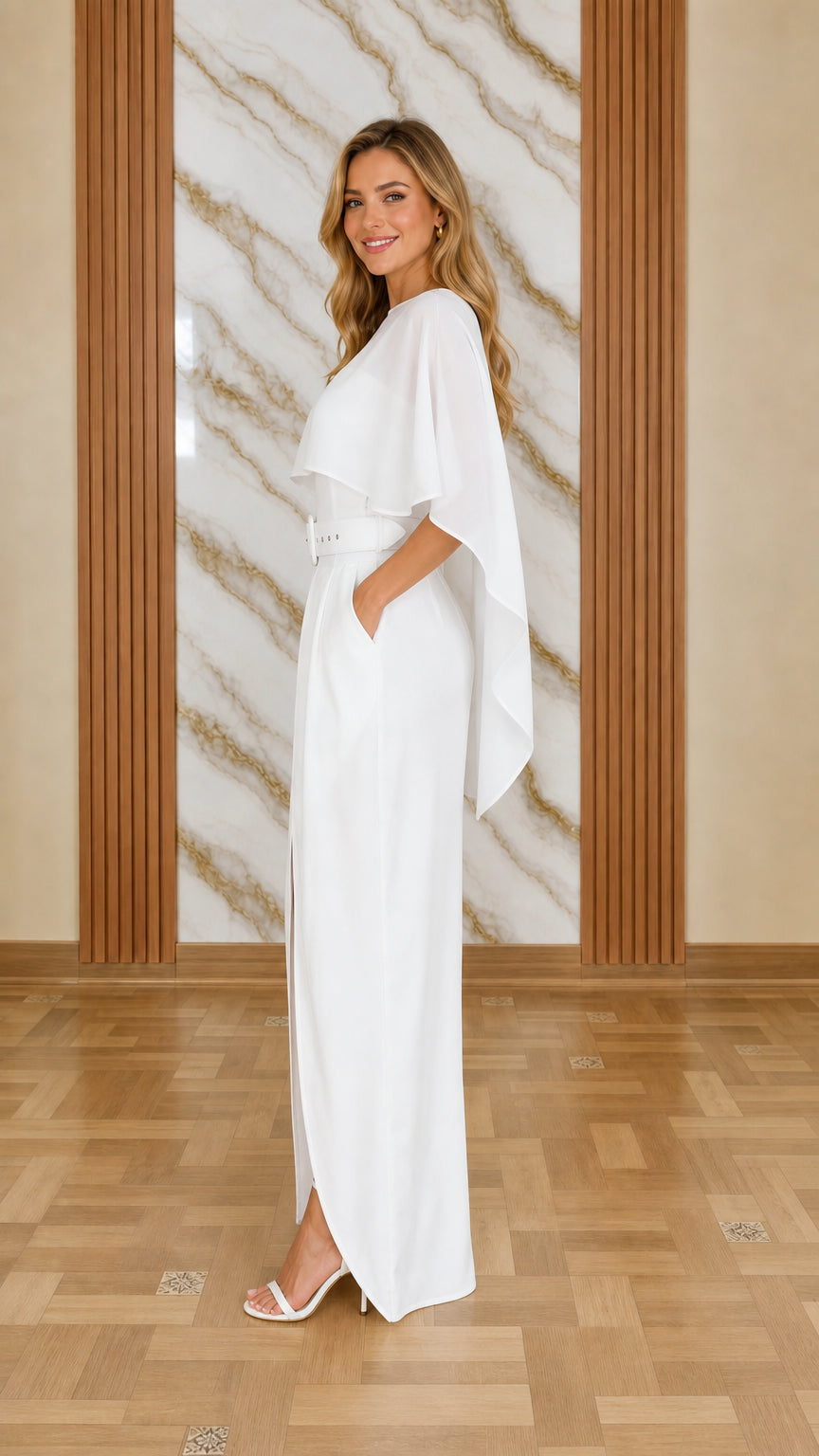 Side profile of model in white cape jumpsuit