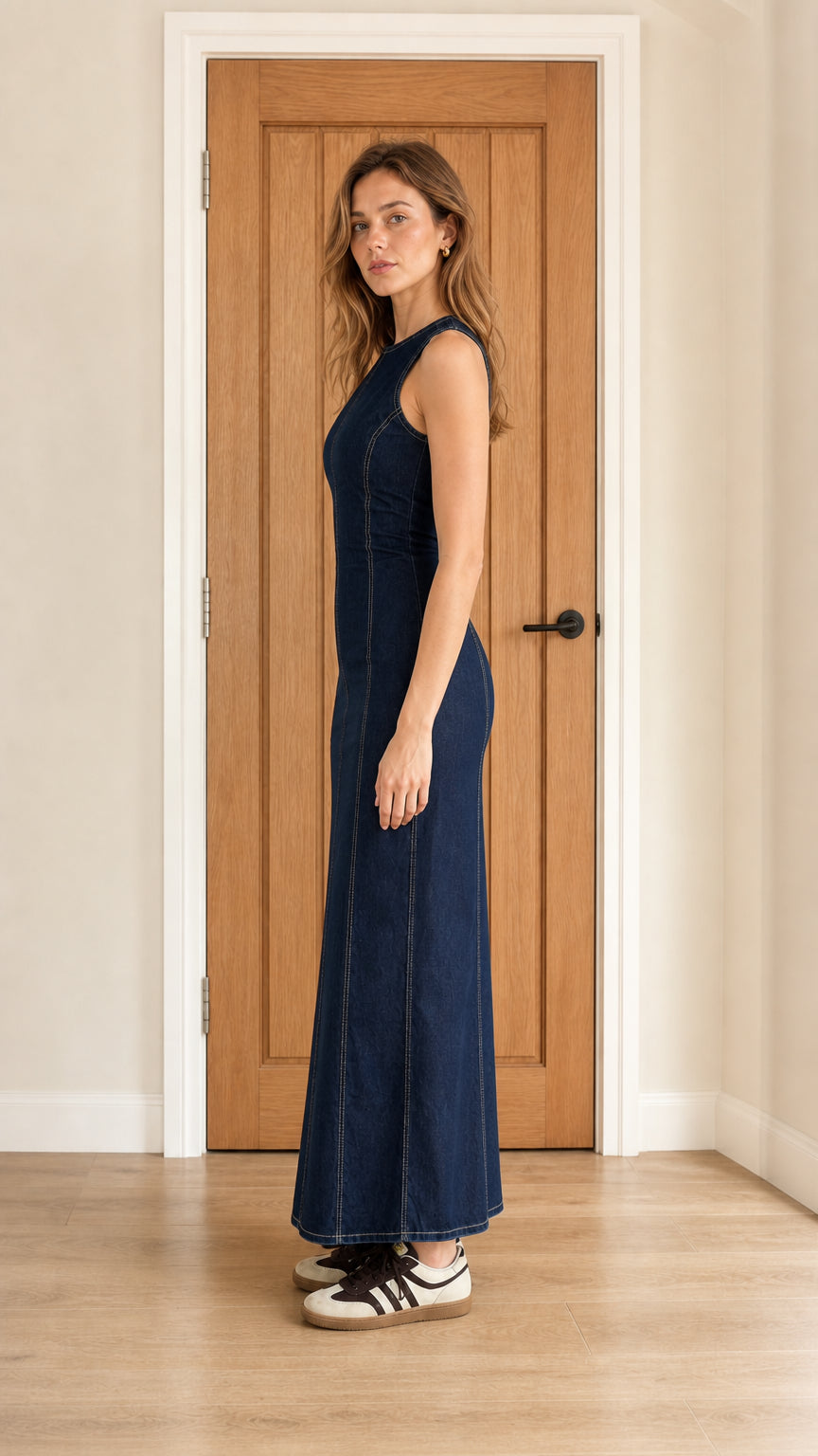 Side profile view of dark blue denim maxi dress