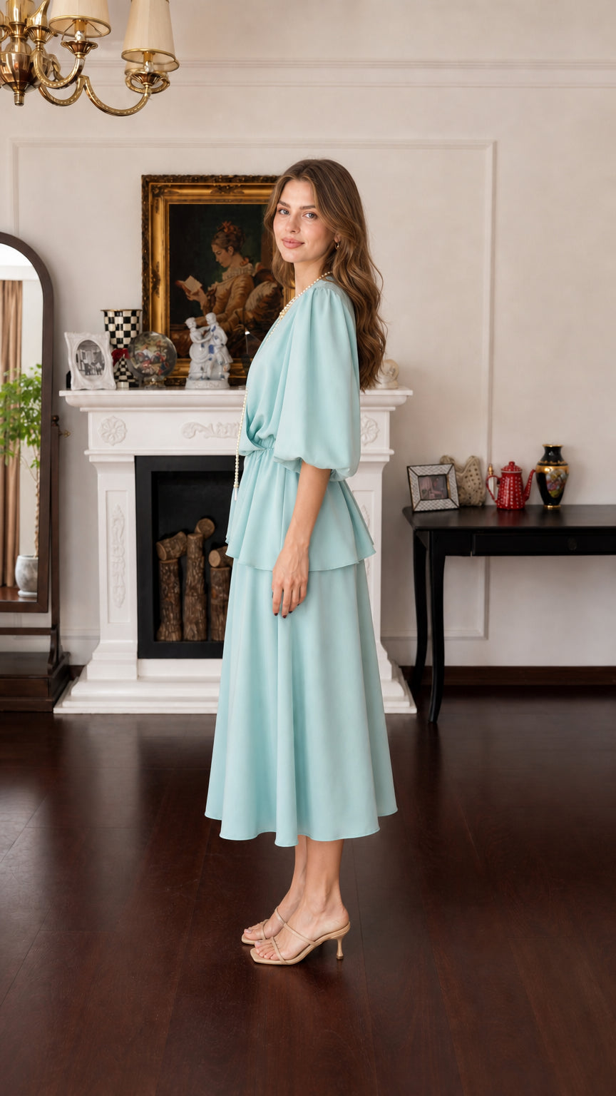 Model wearing mint green midi dress, side view