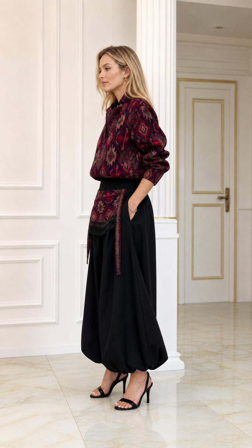 Side profile view of burgundy printed top and draped black harem pants set