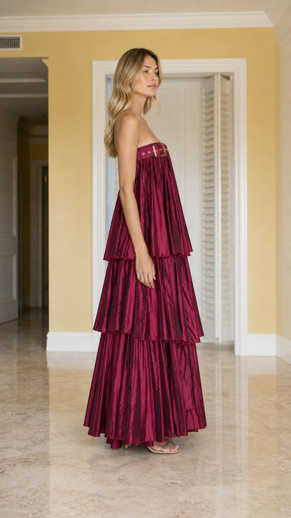 Side angle view of burgundy strapless tiered pleated evening gown