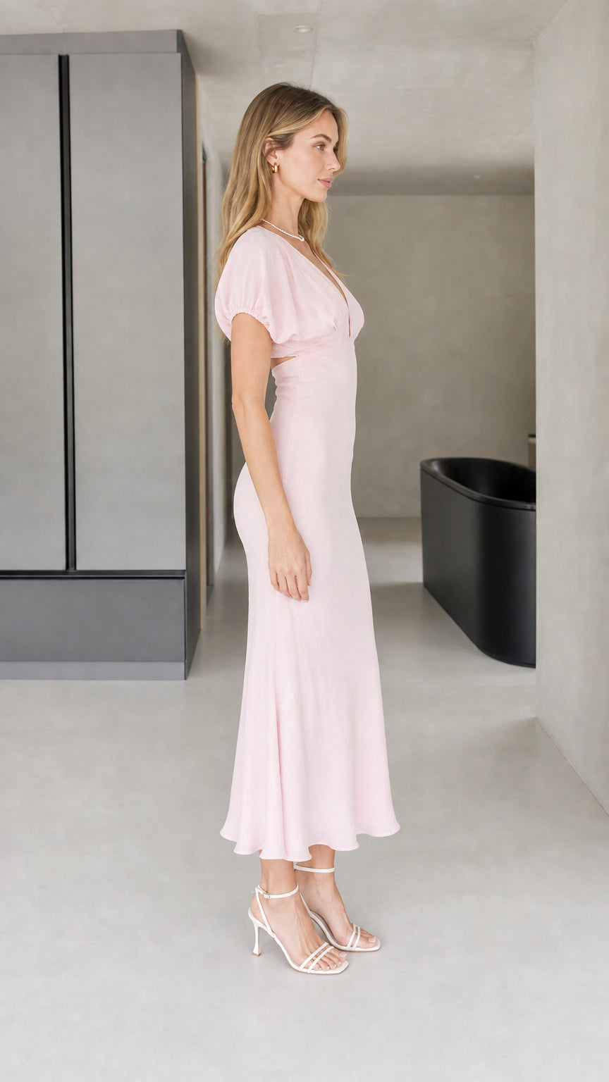 Side profile view of pink flutter sleeve midi dress